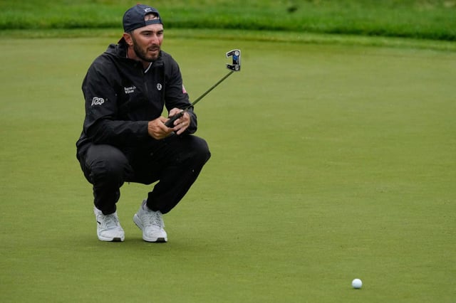 Max Homa lines up his putt on the 13th green during the second round of the Memorial golf tournament, Friday, May 30, 2025, in Dublin, Ohio. (AP Photo/Sue Ogrocki)