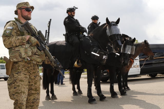 City of Calgary police mounted patrol officers and Cpl. Kevin Jackowski with #P.P.C.L.I., Canadian military on display after a press conference of the joint security forces for the upcoming G7 Meeting.  The information session for the RCMP-led Integrated Safety Security Group (ISSG) held in Calgary, Alta., Monday, June 2, 2025.