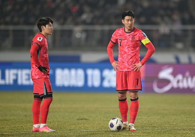 South Korea's Son Heung-min (R) and Lee Kang-in prepare a free kick during a World Cup qualifier
