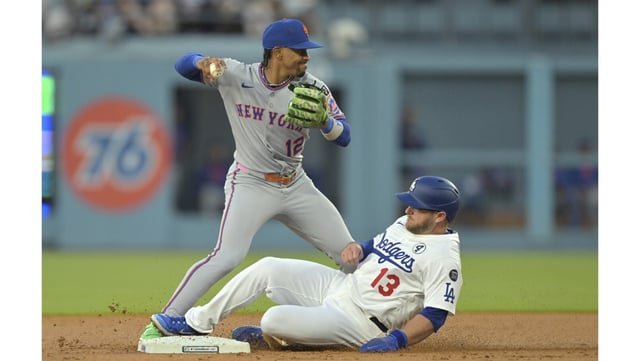 The Dodgers’ Max Muncy is forced out at second base as New York Mets shortstop Francisco Lindor throws to first to complete a double play during the second inning on Monday night at Dodger Stadium. (AP Photo/Jayne Kamin-Oncea)