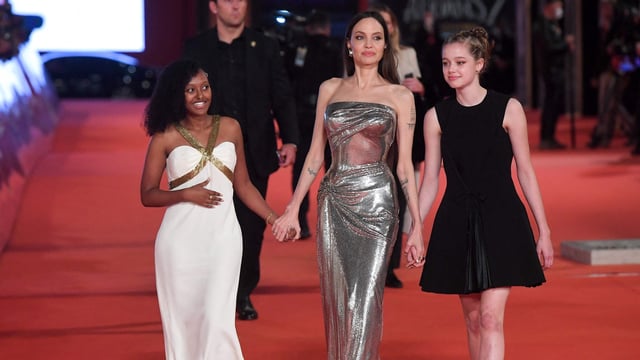 Angelina Jolie arrives with her daughters Zahara (L) and Shiloh (R).