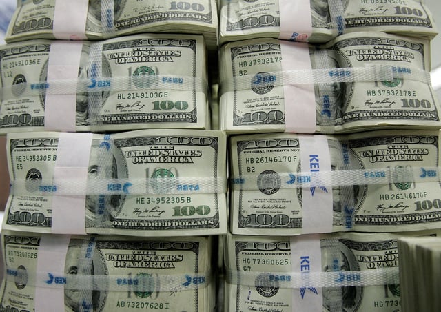 Stacks of one hundred dollar notes are piled up for counting at the headquarters of the Korea Exchange Bank in Seoul February 3, 2009. REUTERS/Jo Yong-Hak//File Photo