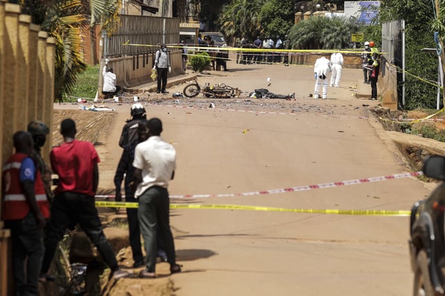 Detectives and forensic investigators work at the scene of a suspected explosive attack in Kampala, Uganda Tuesday, May 3, 2025. (AP Photo/Hajarah Nalwadda)