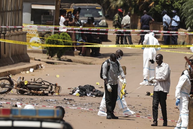 Detectives and forensic investigators work at the scene of a suspected explosive attack in Kampala, Uganda Tuesday, May 3, 2025. (AP Photo/Hajarah Nalwadda)