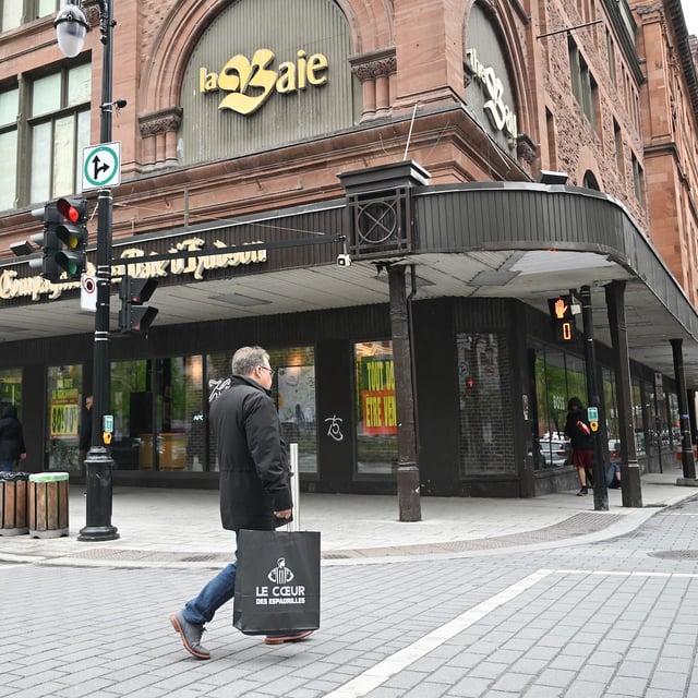 A person walks by a Hudson’s Bay store in Montreal, Sunday, June 1, 2025. It's the final day for the Canadian retailer.  THE CANADIAN PRESS/Graham Hughes