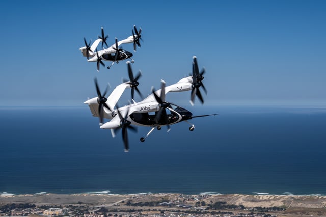Two Joby air taxis (N541JX and N544JX) flying simultaneously in the skies over Marina, CA. Joby Aviation photo