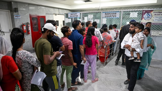 People standing in line to get their reports after Covid-19 test at a district hospital in UP's Noida