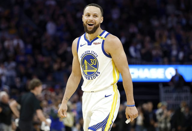 Stephen Curry #30 of the Golden State Warriors reacts after Draymond Green #23 made a three-point shot late in the fourth quarter against the Detroit Pistons at Chase Center on March 08, 2025 in San Francisco, California.