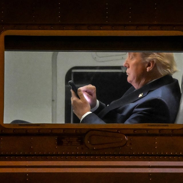 ARCHIV: US-Präsident Donald Trump scrollt auf seinem Handy an Bord der Marine One.