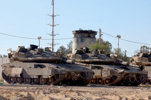 Israeli army tanks take position at the border between Israel and the Gaza Strip on May 29, 2025, amid the ongoing war between Israel and Palestinian militant movement Hamas.