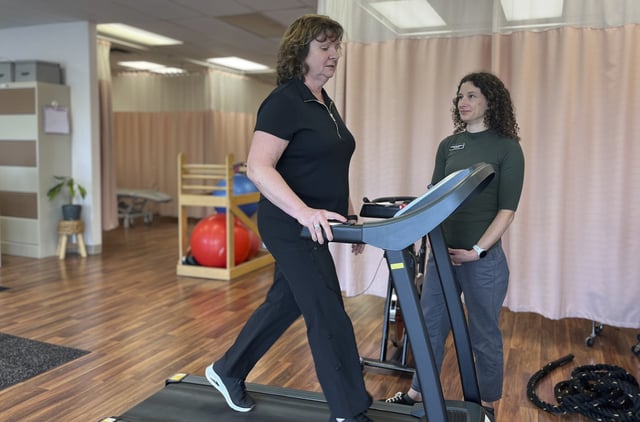 Terri Swain-Collins uses a treadmill in the care of physiotherapist Alison MacDonald on May 20, 2025, at Kingston Injury Management, a clinic in Kingston, Ontario, in Canada. 