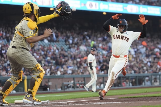 San Diego Padres catcher Elias Díaz, left, forces San Francisco Giants' Willy Adames out at home during the second inning of a baseball game in San Francisco, Monday, June 2, 2025. (AP Photo/Jeff Chiu)