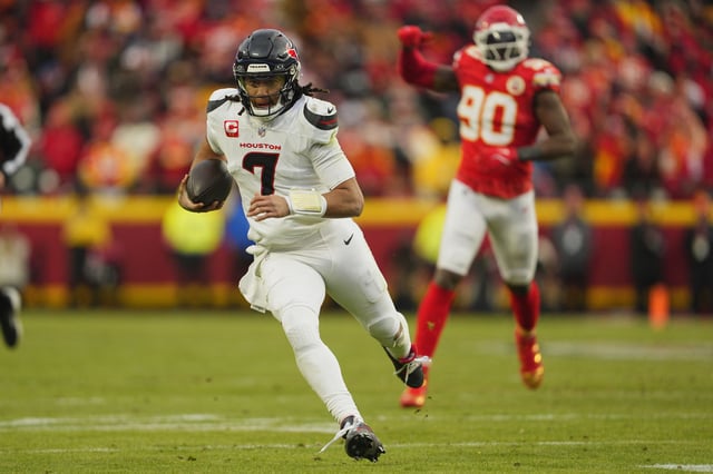 Jan 18, 2025; Kansas City, Missouri, USA; Houston Texans quarterback C.J. Stroud (7) runs the ball against Kansas City Chiefs defensive end Charles Omenihu (90) during the third quarter of a 2025 AFC divisional round game at GEHA Field at Arrowhead Stadium. Mandatory Credit: Jay Biggerstaff-Imagn Images/File Photo