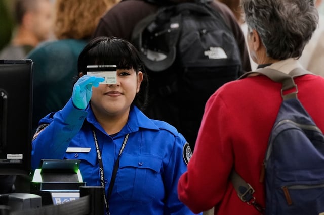 FILE: A TSA contractor checks a traveler&#39;s ID at a security checkpoint in San Francisco International Airport, Wednesday, May 7, 2025.