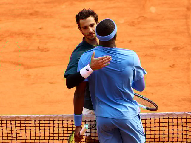 Tennis - French Open - Roland Garros, Paris, France - June 3, 2025 Italy's Lorenzo Musetti speaks with Frances Tiafoe of the U.S. after winning his quarter final match REUTERS/Lisi Niesner