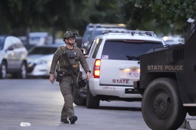 A Louisiana state police SWAT member works the scene on Iberville Street as police pursue a fugitive that escaped from a New Orleans jail, Tuesday, May 20, 2025, in New Orleans.