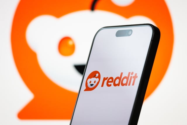In this photo illustration, the logo of Reddit, Inc. is displayed on a smartphone screen, with the company&#39;s mascot and branding visible in the background, on April 26, 2025, in Chongqing, China.