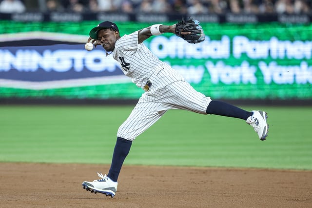 Apr 15, 2025; Bronx, New York, USA;  New York Yankees second baseman Jazz Chisholm Jr. (13) tries to make a running throw to first base in the fifth inning against the Kansas City Royals at Yankee Stadium. All players wore #42 for Jackie Robinson Day.  Mandatory Credit: Wendell Cruz-Imagn Images