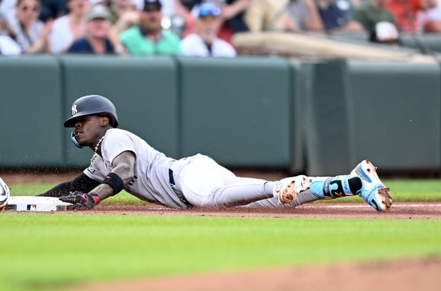 Jazz Chisholm Jr. #13 of the New York Yankees slides into third base after advancing on an error after hitting a double in the first inning against the Baltimore Orioles at Oriole Park at Camden Yards on April 29, 2025 in Baltimore, Maryland. Chisholm left the game after the play with an injury.