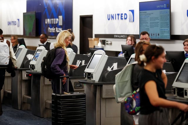 An airline passenger checks in at the United ticket counters at Tampa International Airport in Tampa, Florida, U.S., July 19, 2024. REUTERS/Octavio Jones