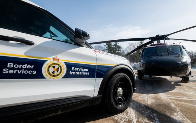 The union representing front line Mounties wants Ottawa to dismiss any notion of shifting border security responsibilities away from the RCMP. A Canada Border Services Agency cruiser is parked next to a RCMP Sikorsky UH-60 Black Hawk at the CBSA Lansdowne port of entry in Lansdowne, Ont., on Feb. 12, 2025. THE CANADIAN PRESS/Spencer Colby