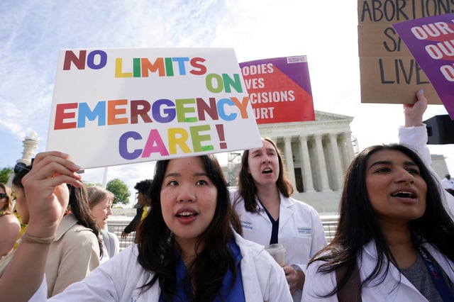 Abortion rights supporters hold placards on the day the Supreme Court justices hear oral arguments over the legality of Idaho's Republican-backed, near-total abortion ban in medical-emergency situations, at the U.S. Supreme Court in Washington, U.S., April 24, 2024. REUTERS/Kevin Lamarque/File Photo