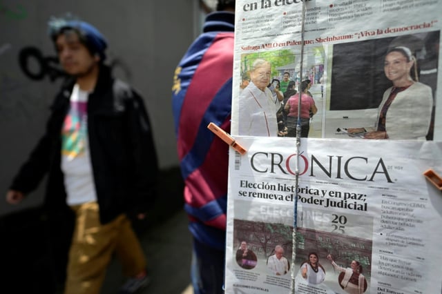 A man walks past a newspaper stand the day after judicial elections in Mexico