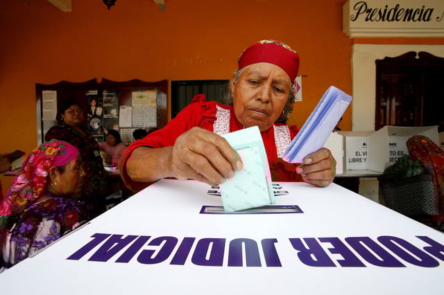 A woman casts a vote during the judicial and magistrate elections in San Bartolome Quialana in Mexico's Oaxaca state on Sunday.