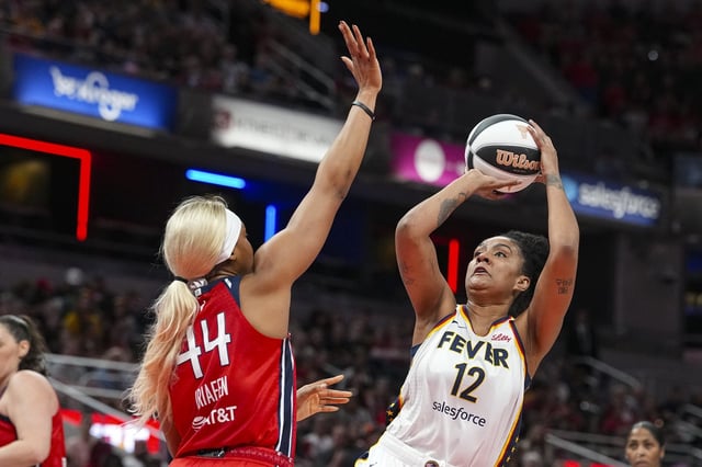 Indiana Fever forward Damiris Dantas (12) shoots over Washington Mystics forward Kiki Iriafen (44) in the first half of a WNBA basketball game in Indianapolis, Tuesday, June 3, 2025. (AP Photo/Michael Conroy)