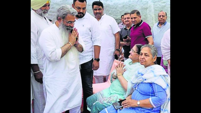 Congress candidate Bharat Bhushan Ashu meets with voters during an election campaign in Ludhiana on Tuesday. (HT Photo)