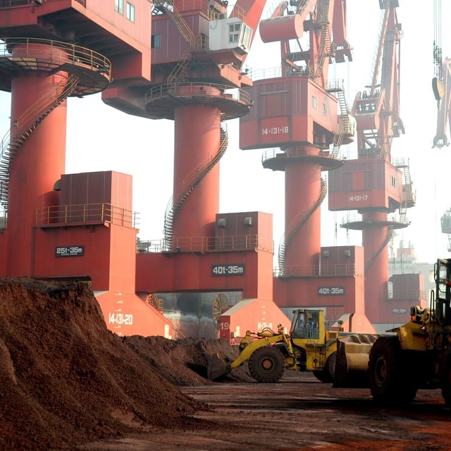 Workers transport soil containing rare earth elements for export at a port in Lianyungang, Jiangsu province, China, in 2010.