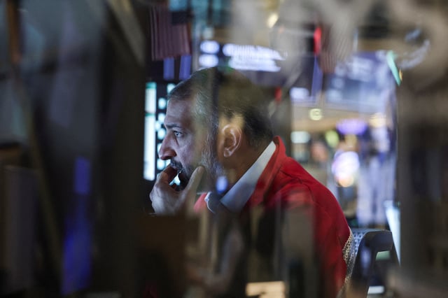 A trader works on the floor at the New York Stock Exchange (NYSE) in New York City, U.S., May 19, 2025. REUTERS/Jeenah Moon/File Photo