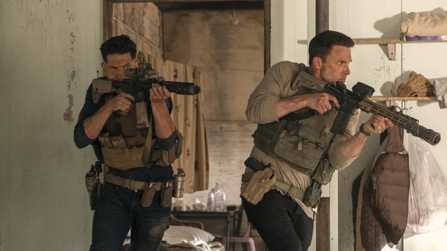 This image released by Amazon shows Jon Bernthal, left, and Ben Affleck in a scene from The Accountant 2. 