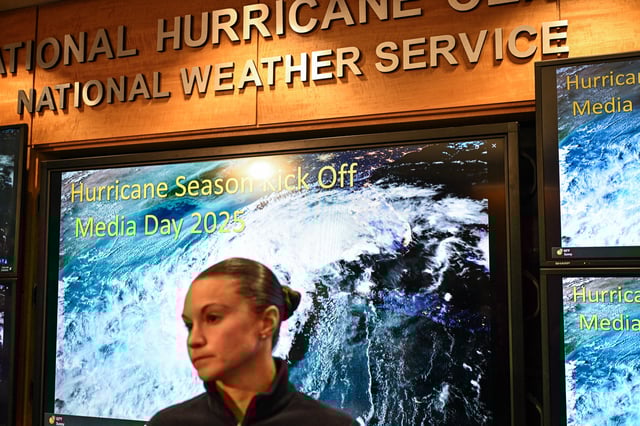 An employee of the National Oceanic and Atmospheric Administration&#39;s (NOAA) National Hurricane Center (NHC) looks on during a news conference at the NHC in Miami, Florida, on May 30, 2025.