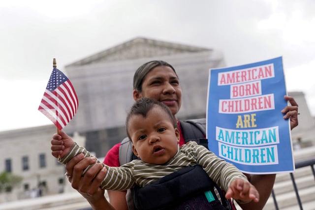 Olga Urbina carries baby Ares Webster as demonstrators rally on the day the Supreme Court justices hear oral arguments over U.S. President Donald Trump's bid to broadly enforce his executive order to restrict automatic birthright citizenship, during a protest outside the U.S. Supreme Court in Washington, D.C., U.S., May 15, 2025. REUTERS/Nathan Howard/File Photo