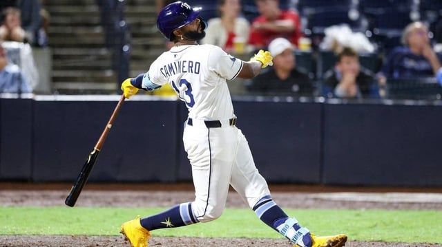 Jun 3, 2025; Tampa, Florida, USA; Tampa Bay Rays third baseman Junior Caminero (13) hits a solo home run against the Texas Rangers in the eighth inning at George M. Steinbrenner Field. Mandatory Credit: Nathan Ray Seebeck-Imagn Images
