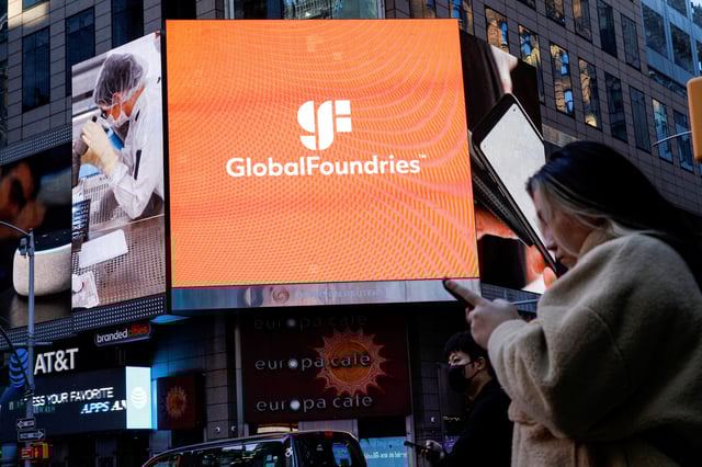 A screen displays the company logo for semiconductor and chipmaker GlobalFoundries Inc. during the company's IPO at the Nasdaq MarketSite in Times Square in New York City, U.S., October 28, 2021.  REUTERS/Brendan McDermid/File Photo