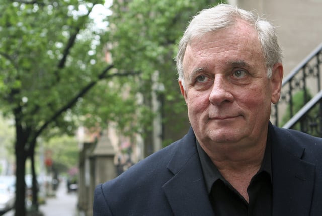 FILE - Author Edmund White stands outside his apartment April 24, 2006 in New York. (AP Photo/Mark Lennihan, file)