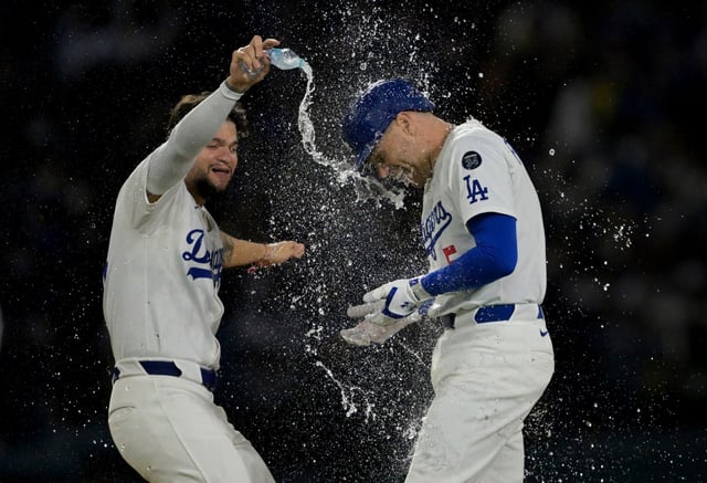 Los Angeles Dodgers&#39; Freddie Freeman, right, is doused with water by Dodgers&#39; Andy Pages after hitting a walk off double in the tenth inning of a baseball game against the New York Mets, Tuesday, June 3, 2025, in Los Angeles. (AP Photo/Jayne Kamin-Oncea)
