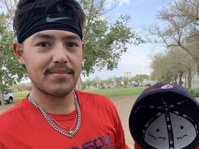 Regina Red Sox pitcher Zander Oudie-Senger shows the "Jesse #33" inscription he wrote inside his cap to honour friend and teammate Jesse Lubiniecki, who died in a vehicle accident on May 29/25 in Montana while driving home to rejoin the Western Canadian Baseball League team.