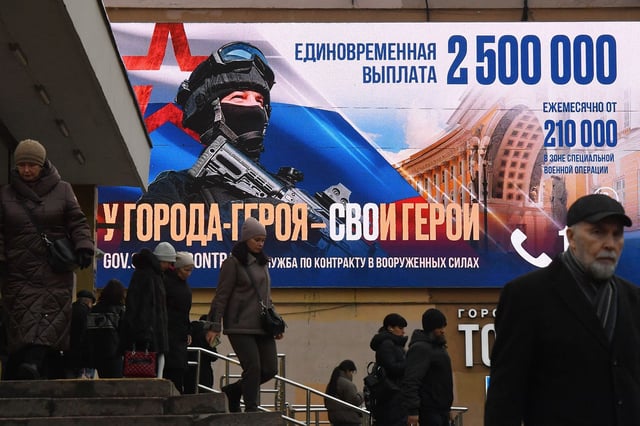 Pedestrians walk past a billboard advertising contract army service in St. Petersburg in January.