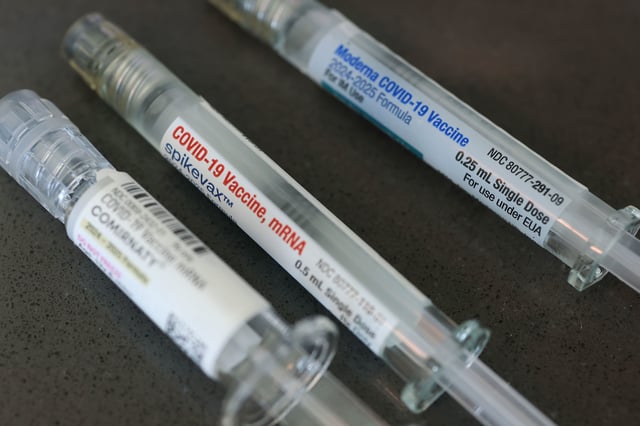 MIAMI, FLORIDA - MAY 29: In this photo illustration,  Pfizer-BioNTech COVID-19 (L) and Moderna COVID-19 vaccines fill their syringes at Borinquen Health Care Center on May 29, 2025 in Miami, Florida. Health and Human Services Secretary Robert F. Kennedy Jr. announced that he will no longer recommend that healthy children and pregnant people get COVID-19 shots. (Photo illustration by Joe Raedle/Getty Images)