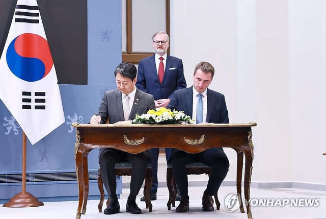 This photo, provided by the industry ministry, shows Industry Minister Ahn Duk-geun (L) with Czech Prime Minister Petr Fiala (C) in Prague on May 7, 2025. (PHOTO NOT FOR SALE) (Yonhap)