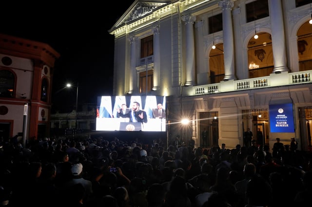 Supporters watch El Salvador's President Nayib Bukele deliver a speech at an event, to mark the first year of his second term in office, in San Salvador, El Salvador June 1, 2025. REUTERS/Jose Cabezas