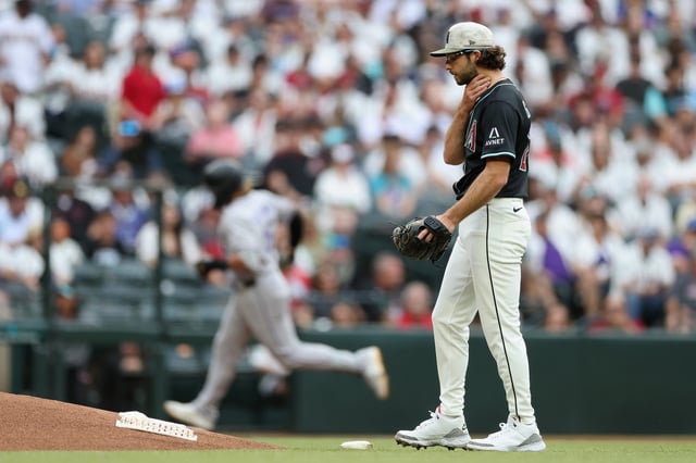 PHOENIX, ARIZONA - MAY 17: Starting pitcher Zac Gallen #23 of the Arizona Diamondbacks reacts after giving up a home run to Hunter Goodman #15 of the Colorado Rockies during the first inning of the MLB game at Chase Field on May 17, 2025 in Phoenix, Arizona.