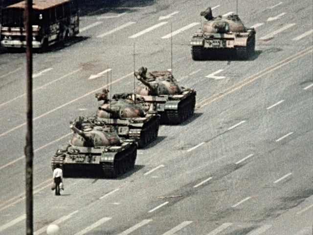 A Beijing demonstrator blocks the path of a tank convoy along the Avenue of Eternal Peace near Tiananmen Square. For weeks, people have been protesting for freedom of speech and of press from the Chinese government.