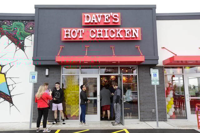 Customers wait in line during the grand opening of Dave's Hot Chicken Friday, April 25, 2025, in Grand Chute, Wisconsin.