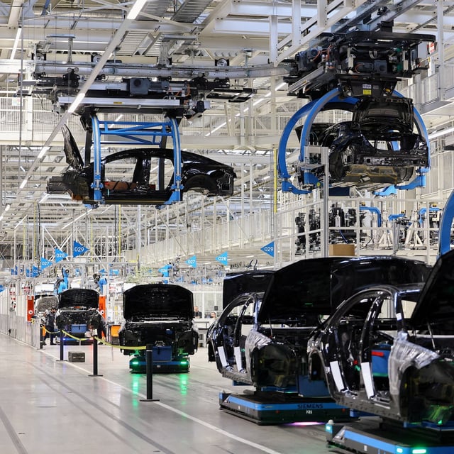 FILE PHOTO: Car bodies are lifted at "Factory 56", one of the world's most modern electric and conventional car assembly halls of German carmaker Mercedes-Benz, in Sindelfingen near Stuttgart, Germany, March 4, 2024. REUTERS/Wolfgang Rattay/File Photo