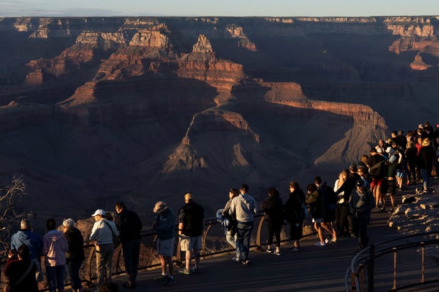 Tourists gather to watch the sunset over the south rim of Grand Canyon National Park near Tusayan, Arizona, U.S., May 16, 2025.  REUTERS/Rebecca Noble/File Photo
