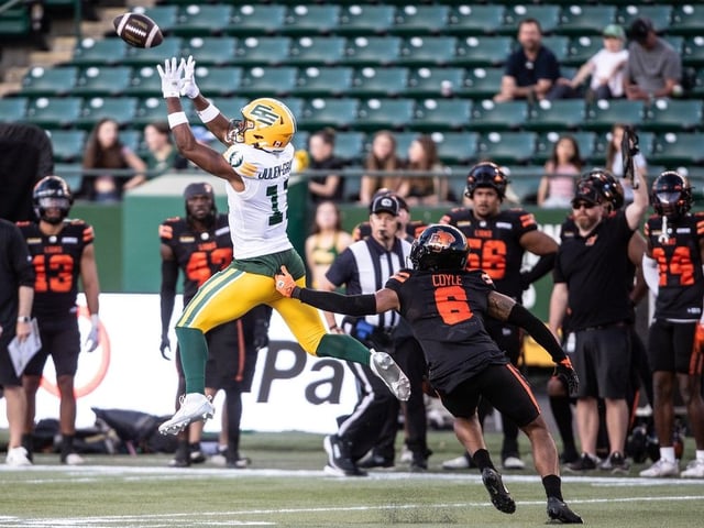B.C. Lions' Tyler Coyle (6) tries to stop Edmonton Elks' Kaion Julien-Grant (11) as he makes the catch during first half CFL pre-season action in Edmonton, on Friday May 30, 2025.